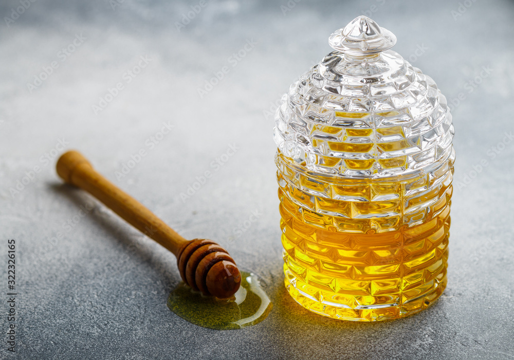 honey in jar with dipper on white background honey in jar with dipper on white background