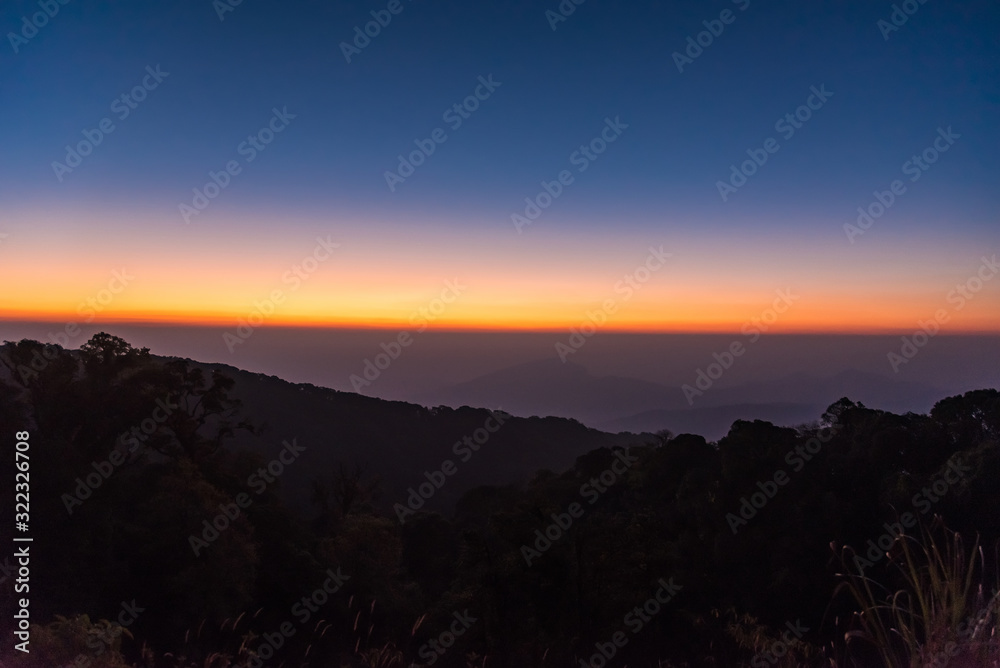Sunrise at Doi Inthanon, mountain view misty morning of alone tree and many hills with red sky background. Sunrise at Doi Inthanon, mountain view misty morning of alone tree and many hills with red sky background.