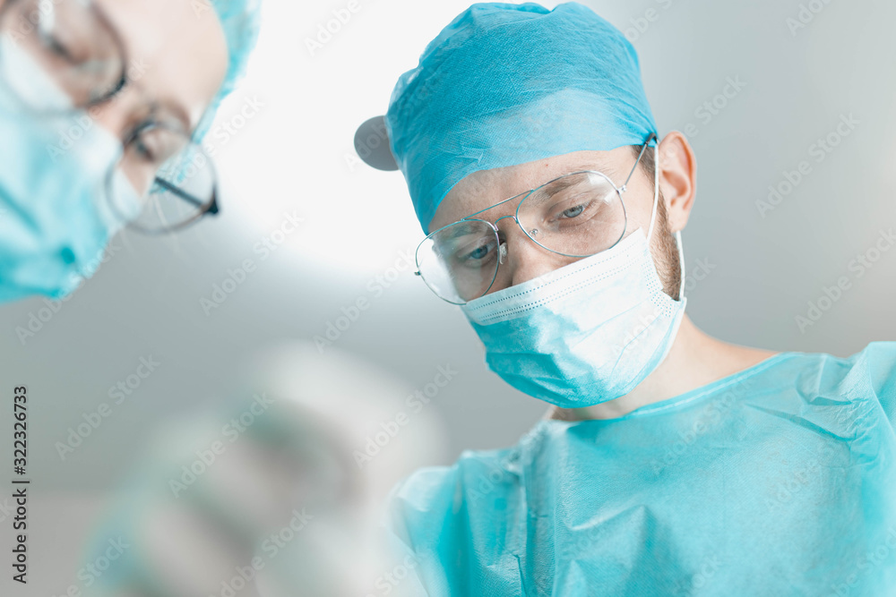 surgeon doctor with assistant student girl in the operating room. first-person view of the patient. surgeon doctor with assistant student girl in the operating room. first-person view of the patient.