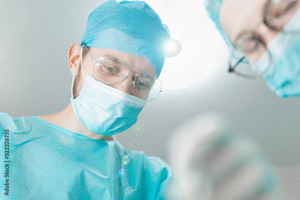 surgeon doctor with assistant student girl in the operating room. first-person view of the patient. surgeon doctor with assistant student girl in the operating room. first-person view of the patient.