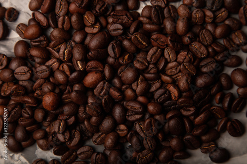 Composition with a coffee beans on a textured plastered background with a variety of arbitrary stains