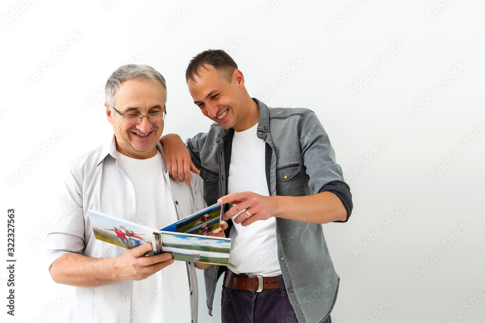 Father and son reviewing their vacation pictures Father and son reviewing their vacation pictures