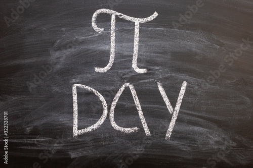 The symbol of number PI day written chalk on a blackboard