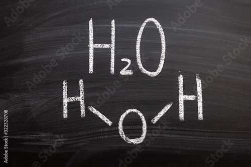 Water element chemical formula on chalkboard