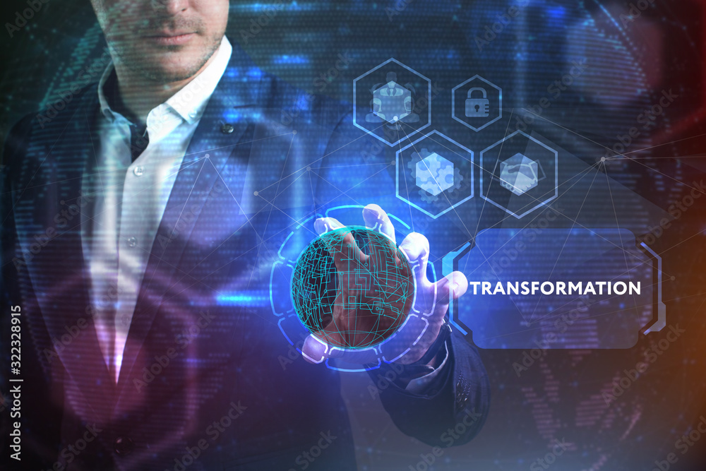 Business, Technology, Internet and network concept. Young businessman working on a virtual screen of the future and sees the inscription: Transformation Business, Technology, Internet and network concept. Young businessman working on a virtual screen of the future and sees the inscription: Transformation