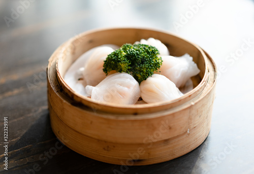 tradition Chinese prawn dumplings (hagao) placed in a bamboo steamer photo