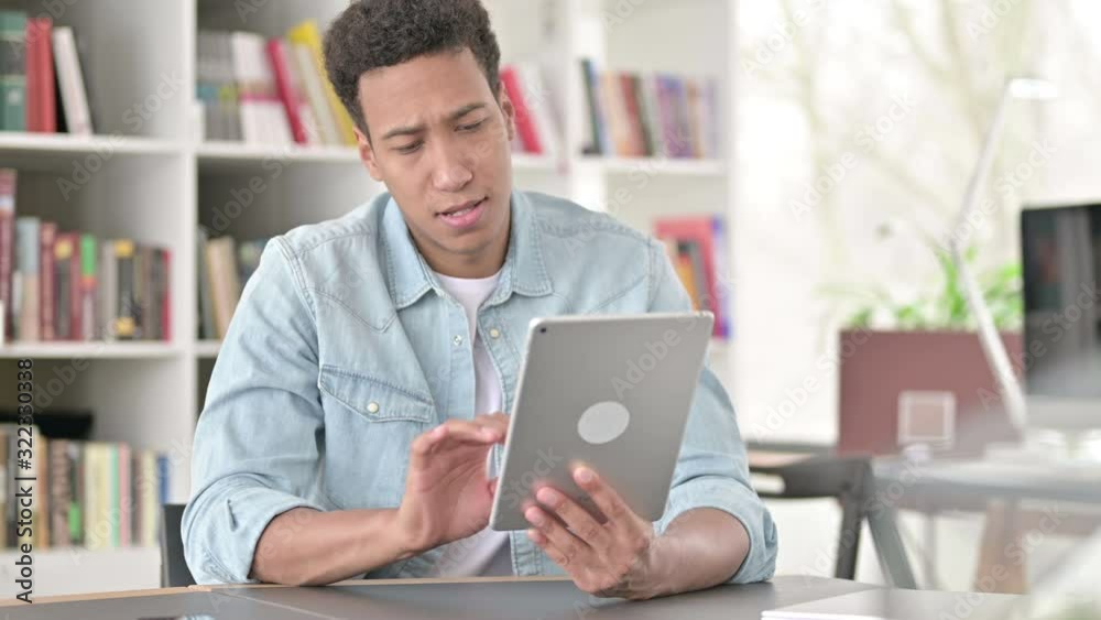 Creative Young African American Man using Digital Tablet 