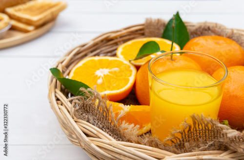 Orange juice, oranges and toast on white vintage wood table