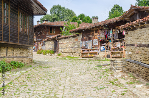 Stone street and souvenir shop in the 19th century village of Zheravna, Bulgaria photo