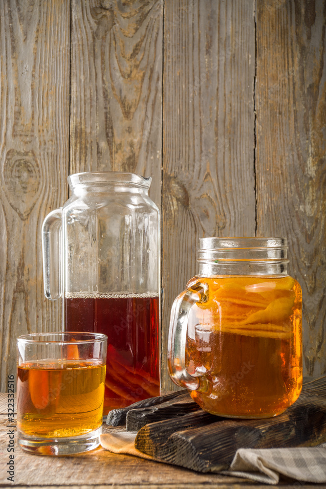 Fermented drink, Homemade sweet fermented tea Kombucha, in different jars and glasses Fermented drink, Homemade sweet fermented tea Kombucha, in different jars and glasses