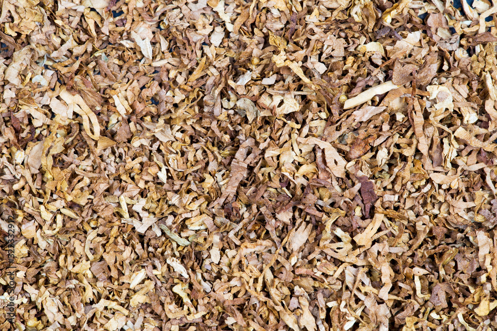 Closeup background of brown dry tobacco, smoking concept Closeup background of brown dry tobacco, smoking concept