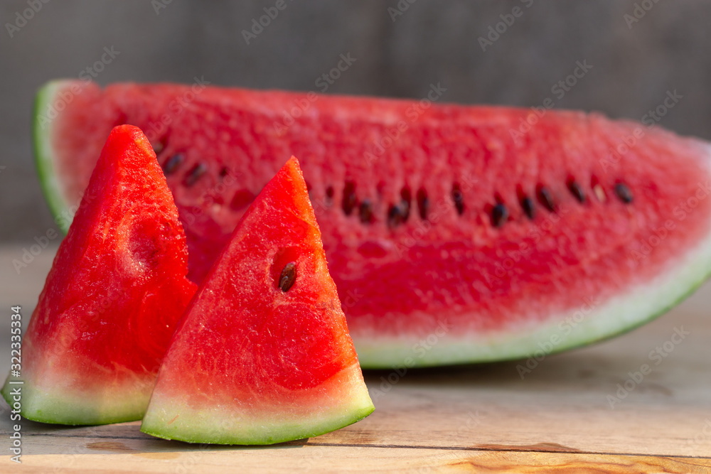Fresh sliced watermelon, on the wooden table.