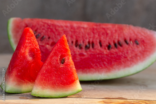 Fresh sliced watermelon, on the wooden table.