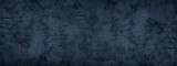Black grunge background. Dark blue rough dirty surface texture. Close-up. Distressed backdrop. Blue abstract wide grunge banner with copy space for your design. Panorama.