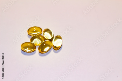 capsules of fish oil lie on a hand on a light background. view from above. vitamins for health.