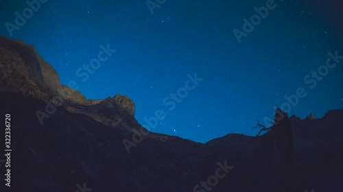 Stars and moon over mountains