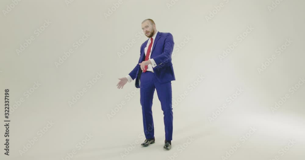 Young, confident and smartly dressed businesman dancing on a white background - Slow Motion, Wide Shot Young, confident and smartly dressed businesman dancing on a white background - Slow Motion, Wide Shot