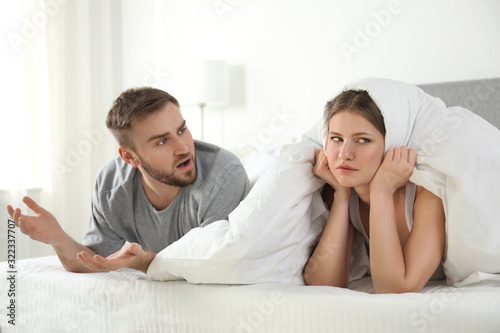 Unhappy young couple quarreling at home. Relationship problems