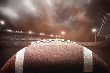 American football ball on dark background