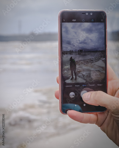Photo of a boy on an ice floe on your phone in photos