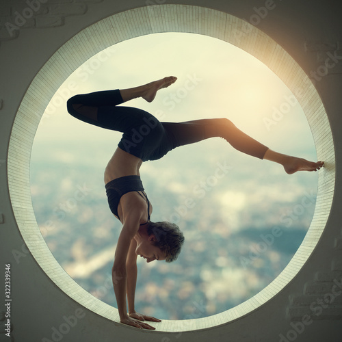 Obraz na plátně Beautiful sporty fit yogi woman practices yoga handstand asana Bhuja Vrischikasa