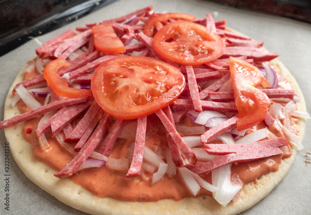 Pizza making process. Pizza dough with raw ingredients, close up Pizza making process. Pizza dough with raw ingredients, close up
