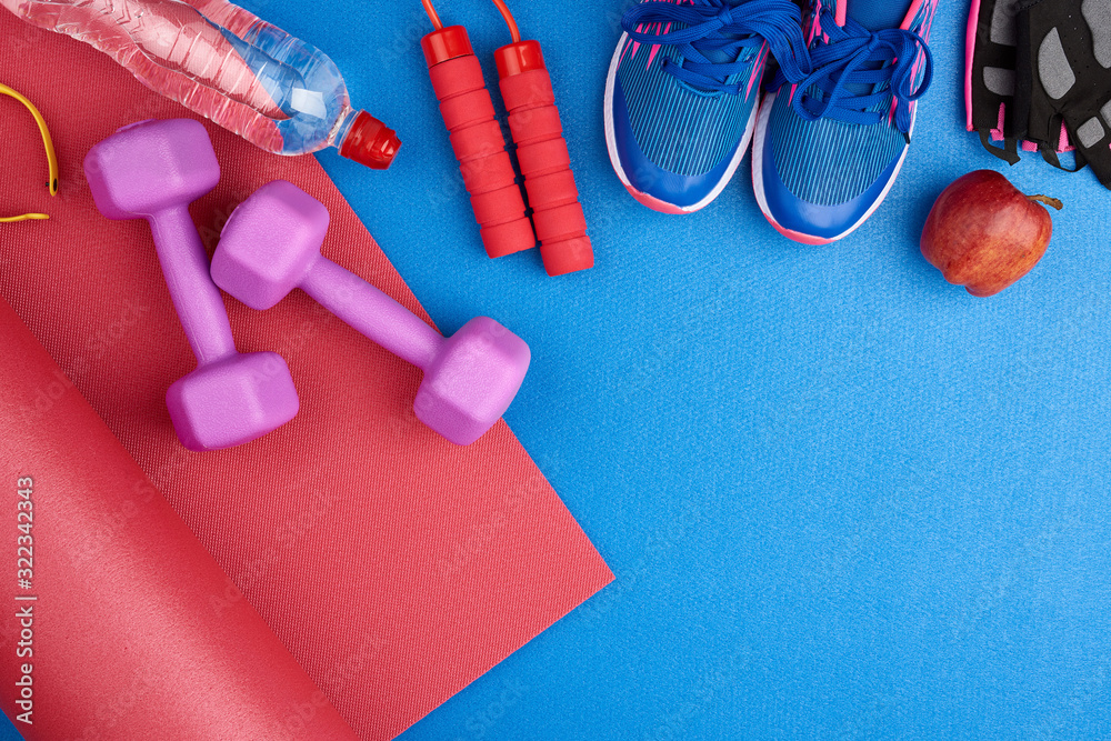 pair of blue training sneakers with laces, bottle of water pair of blue training sneakers with laces, bottle of water