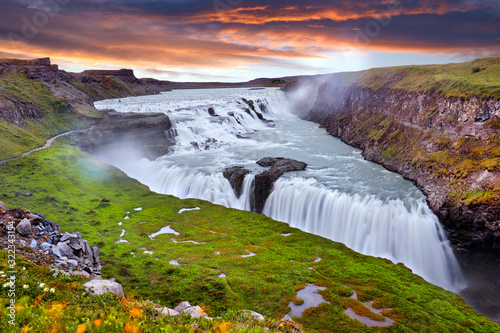 Panoramic view on Gullfoss waterfall on the Hvíta river, a popular tourist attraction and part of the Golden Circle Tourist Route in Southwest Iceland. Golden Waterfall. Travelling concept background.