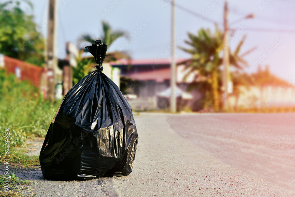 Premium Photo  A large black garbage bag on the side of the road