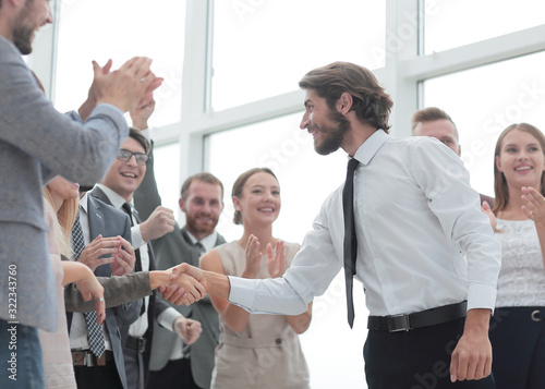 corporate group of employees congratulating each other on the victory