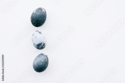 Natural dyed blue colored eggs on white background.