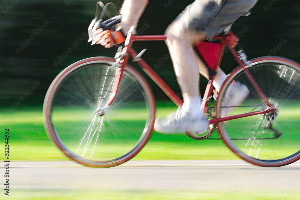 Fototapeta premium Riding bicycle - blurred motion, fast driving.