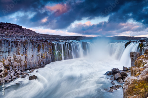 Colorful clouds over Selfoss waterfall. Iceland, Jokulsa National Park, Fjollum river, Europe. . Popular tourist attraction. Travelling concept background. Golden Ring Of Iceland. Beautiful Postcard.