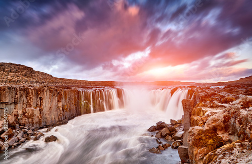 Colorful clouds over Selfoss waterfall. Iceland, Jokulsargljufur National Park, Fjollum river, Europe. Popular tourist attraction. Travelling concept background. Golden Ring. Beautiful Postcard..