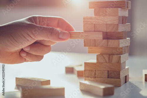 Fotografie close up of hand playing block wood with sunshine background