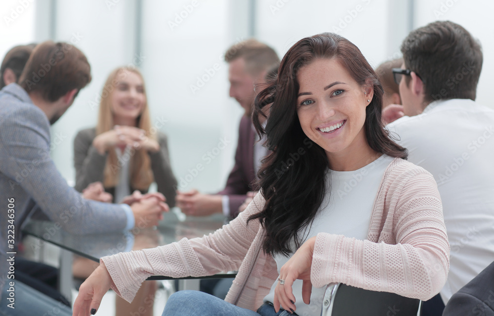 successful business woman sitting in front of a table in a conference room.