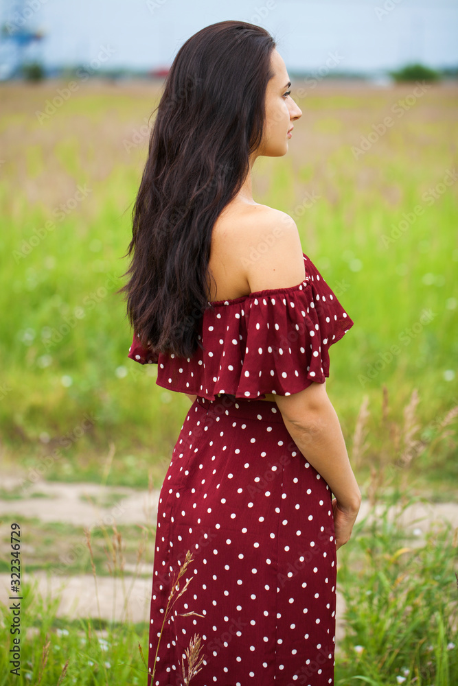 Female brunette hair, rear view, summer park Female brunette hair, rear view, summer park
