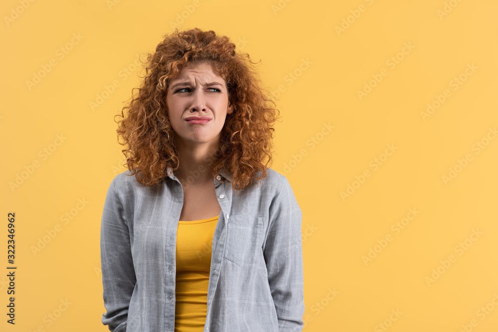 beautiful upset girl crying isolated on yellow beautiful upset girl crying isolated on yellow
