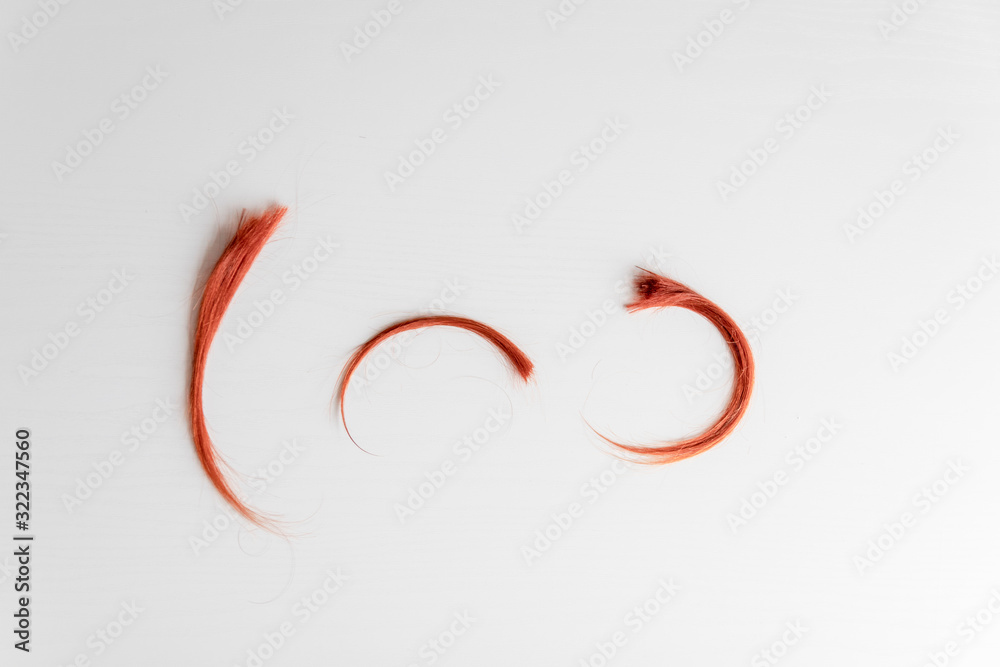 Closeup of hair lock on a gray background. Hairdressing Salon Concept Closeup of hair lock on a gray background. Hairdressing Salon Concept