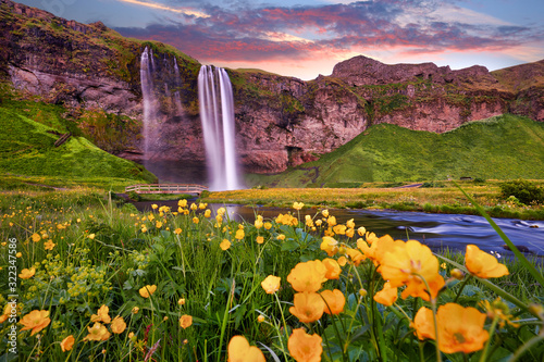 Incredible sunset on Seljalandsfoss. One of the most beautiful waterfalls on the Iceland, Europe. Popular and famous tourist attraction summer holiday destination in on South Iceland. Travel postcard.