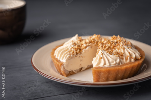 Wallpaper Mural Cut cake basket with caramel near cappuccino on black wooden background. Torontodigital.ca