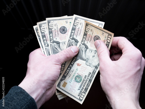Dollars stack in hands. Man holding american dollars