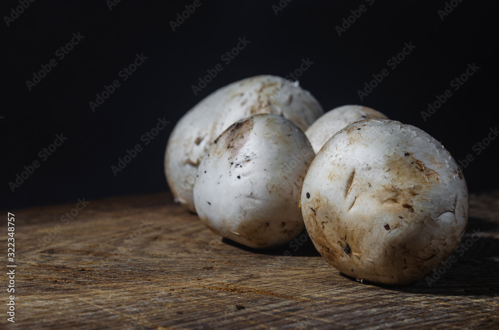 fresh mushrooms on an old wooden board fresh mushrooms on an old wooden board