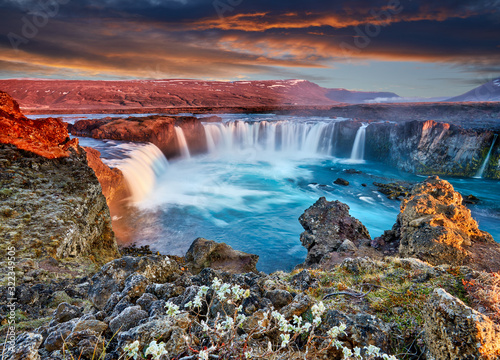Incredible frosty morning and sunrise at the most famous place of Golden Ring Of Iceland. Godafoss waterfall near Akureyri in the Icelandic highlands, Europe. Popular tourist attraction. Postcard.