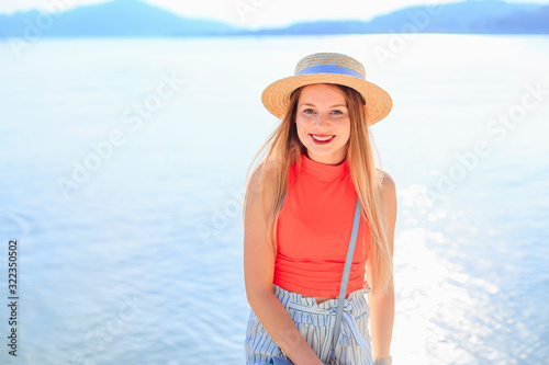 girl with freckles in stylish clothes and boater smiles and look © Ivan