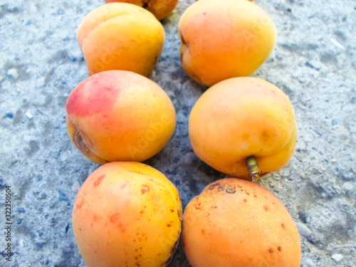 many apricots on a concrete wall. Closeup of fresh apricots as a background