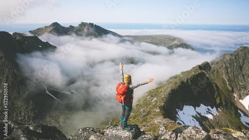 Woman traveler hiking in mountains girl with backpack adventure travel healthy lifestyle happy raised hands active summer vacations explore Norway