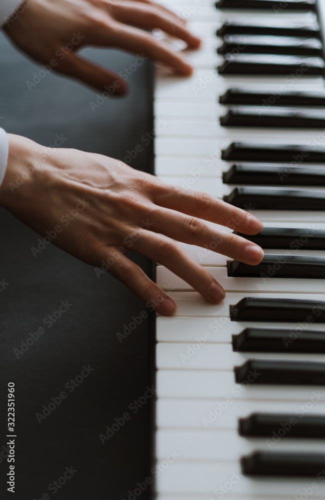 Hands of musician. Pianist playing on a midi keyboard indoor Hands of musician. Pianist playing on a midi keyboard indoor