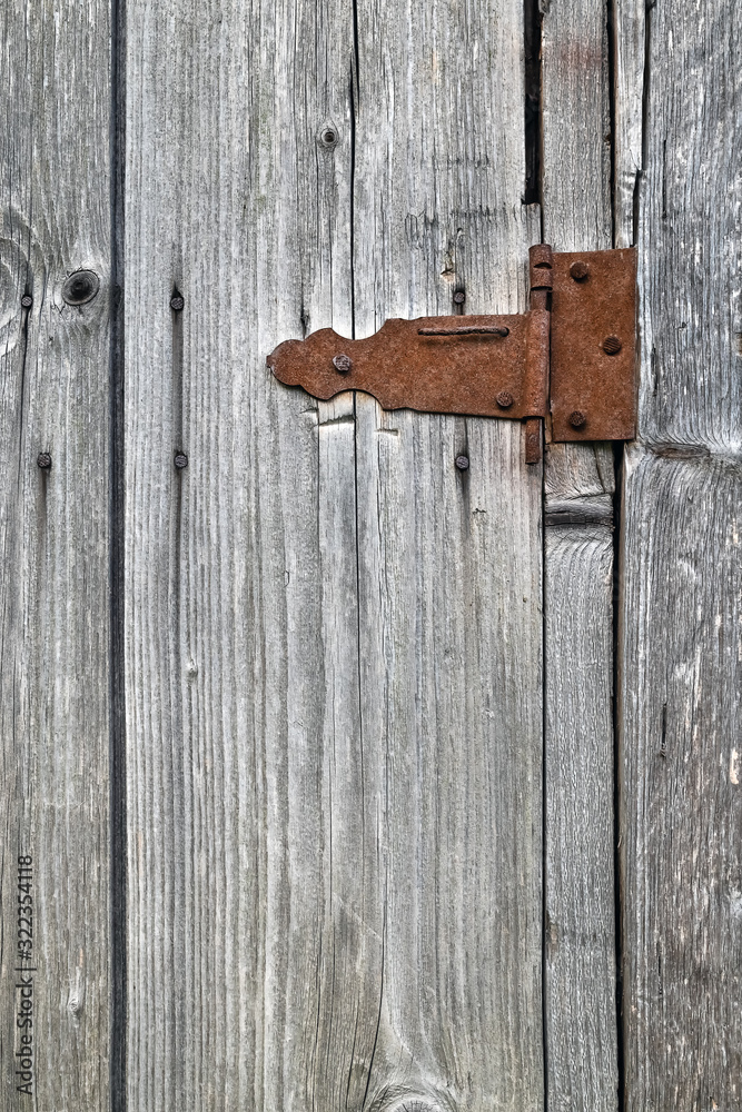 Old wooden not painted background, with rusty metal hinge Old wooden not painted background, with rusty metal hinge