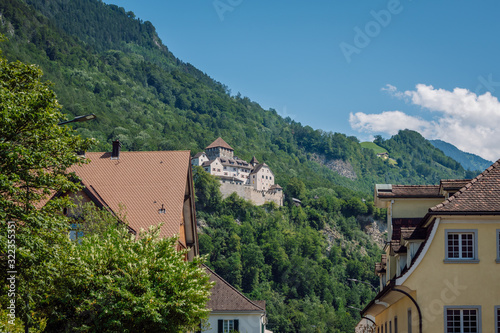 View of Vaduz Castle ( Schloss Vaduz ) situated on a green hill above the capital of Liechtenstein, the city of Vaduz.